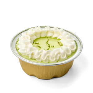 close up view key lime pie mini cheesecake with whip cream on top in a mini cup